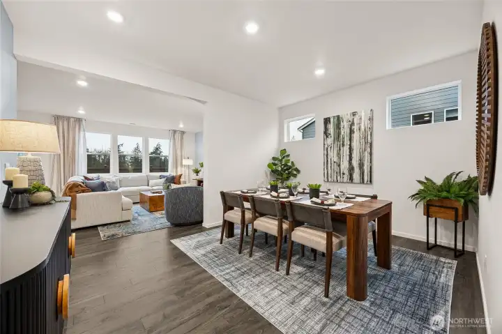 Formal dining room flows into great room. Photo is representational. Actual home is under construction and colors, materials, and finishes may vary. See site agent for details.