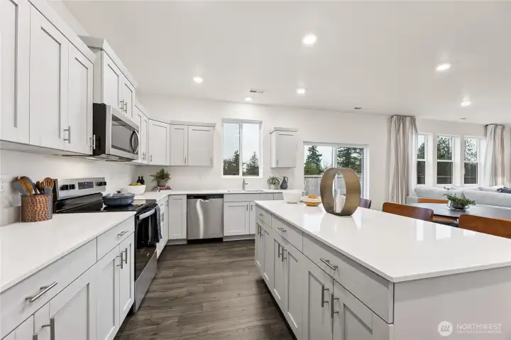 Lot's of cabinetry and storage in the kitchen and island. Actual home is under construction and colors, materials, and finishes may vary. See site agent for details.