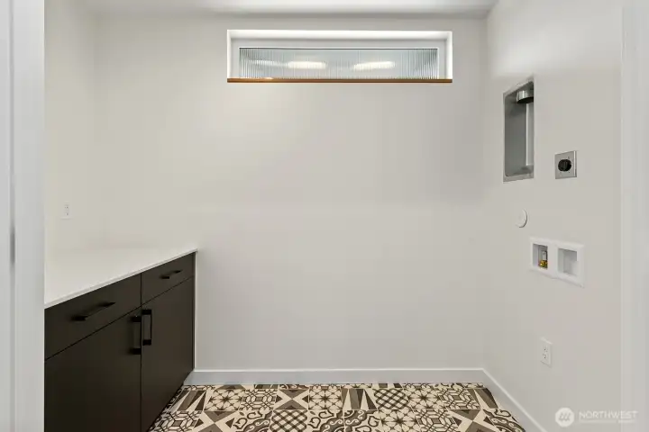 Full-size laundry room with additional storage on the second floor.