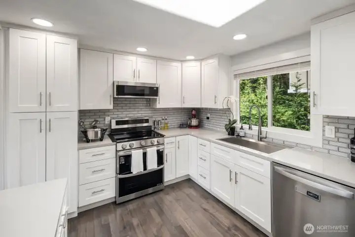 Beautifully renovated kitchen with quartz countertops, stainless appliances, and an open layout designed for connection and entertaining Beautifully renovated kitchen with quartz countertops, stainless appliances, and an open layout designed for connection and entertaining