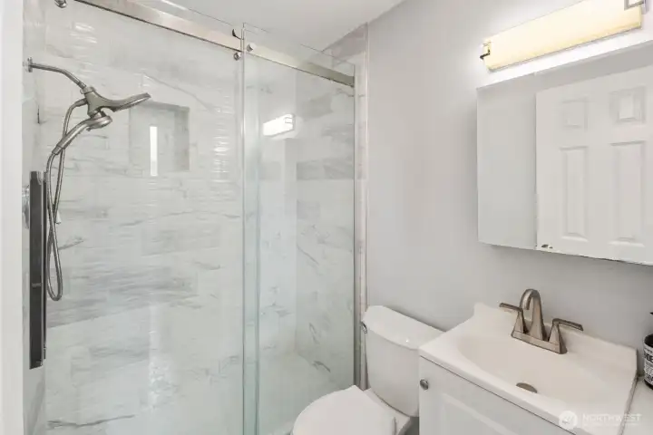 Renovated bathroom with elegant tile surround and refreshed finishes designed for modern everyday comfort Renovated bathroom with elegant tile surround and refreshed finishes designed for modern everyday comfort