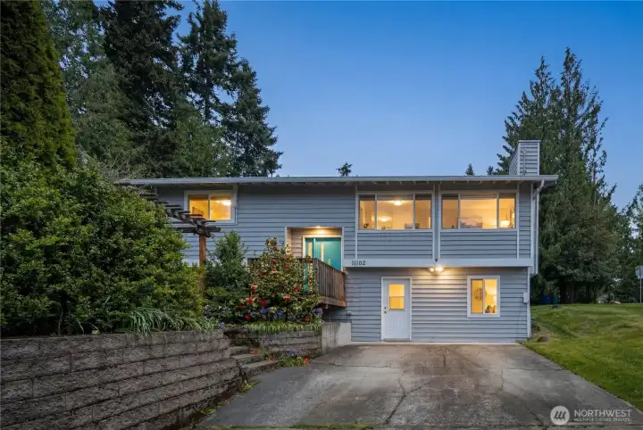 Twilight exterior glowing warmly at dusk, highlighting the inviting atmosphere and beautiful curb appeal Twilight exterior glowing warmly at dusk, highlighting the inviting atmosphere and beautiful curb appeal
