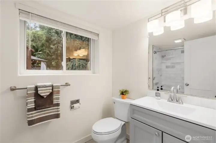 Three-quarter bath, lower level. Marble tile shower, new vanity and lighting. Three-quarter bath, lower level. Marble tile shower, new vanity and lighting.