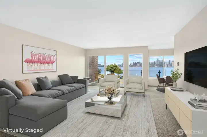 From the moment you step inside this beautifully designed two-level townhouse-style condo, you’re welcomed by breathtaking panoramic views of the Seattle skyline and Puget Sound. The spacious living room is filled with natural light and provides the perfect setting for entertaining guests, hosting cozy evenings at home, or simply relaxing with a good book while taking in the ever-changing beauty of the water and city beyond.