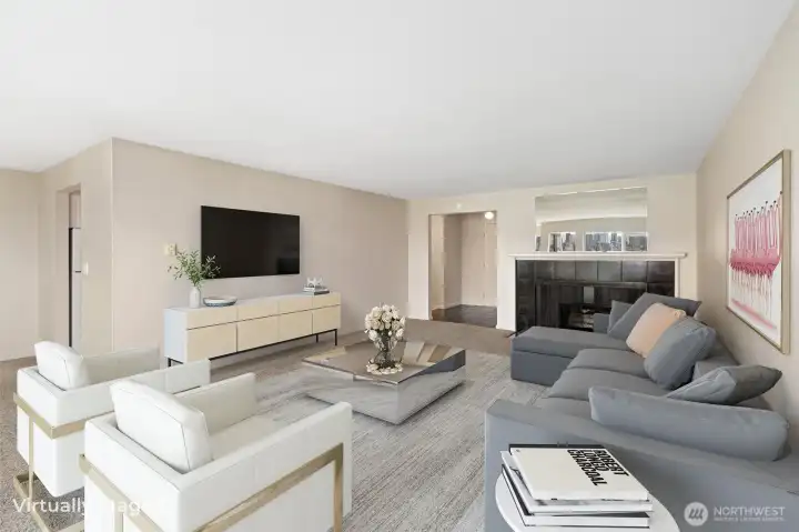 The living room offers a welcoming perspective toward the entryway, with a seamless flow that continues to the left into the kitchen, creating a connected layout ideal for everyday living and entertaining.