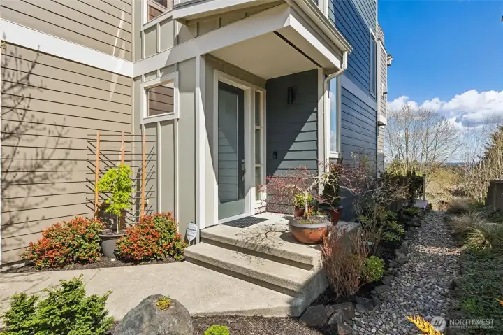 Welcoming front walkway and covered door. Siding completely replaced in 2024 with high quality material and baked on paint.