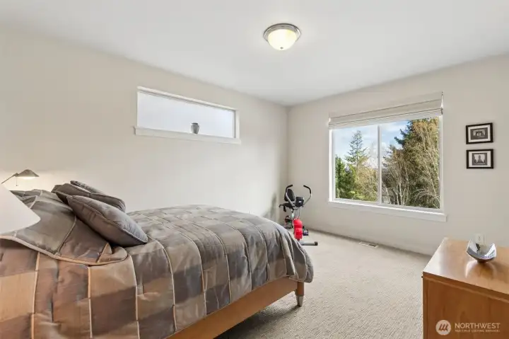First floor primary suite is spacious and airy, with attached en suite bath and walk in closet.