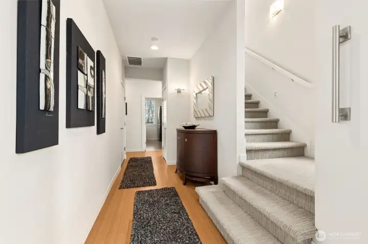 View from the front door, looking straight to the utility room. Garage access and bedroom are to the left down the hall. On the right is an oversized closet with extra storage under the stairs. Shall we go up?