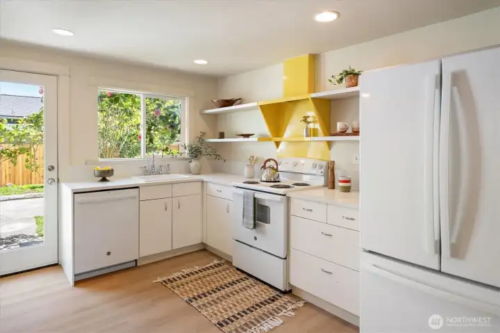 Main Residence | Updated kitchen with generous workspace and views to the grounds beyond. Main Residence | Updated kitchen with generous workspace and views to the grounds beyond.