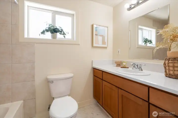 Main Residence | Full bath with generous vanity and natural light. Main Residence | Full bath with generous vanity and natural light.