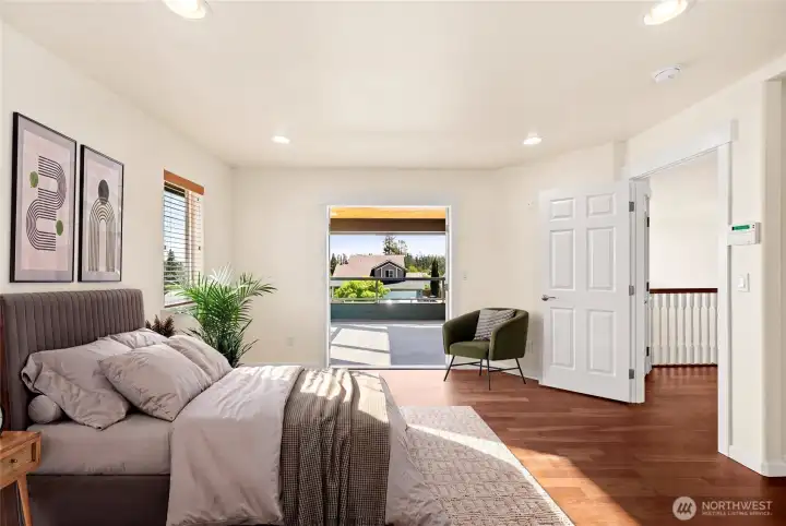 Virtually staged primary bedroom with french doors onto balcony.