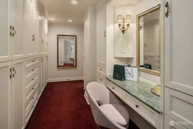 A large dressing room with ample closet space and a built-in vanity can be found in the primary suite.