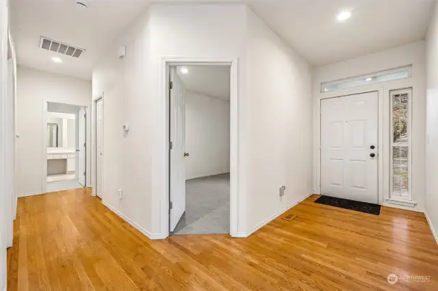 Timeless hard wood floors throughout entry, hallway and kitchen.