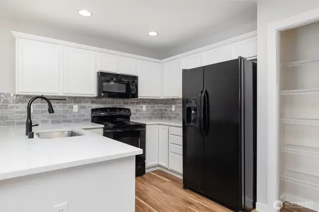 Another view of the kitchen, with adequate storage and plenty of counter space!
