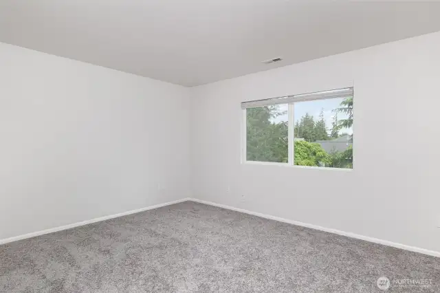 Primary bedroom features new carpet, fresh paint and plenty of space!
