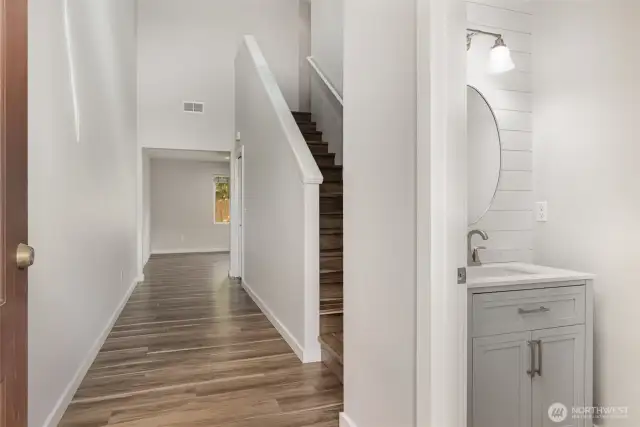 Enter into the home and be greeted by soaring vaulted ceilings and durable vinyl flooring.
