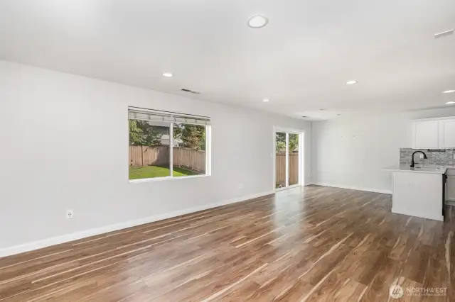 Enjoy a great open floor plan filled with natural light from large windows, complemented by recessed lighting for a bright and inviting atmosphere.