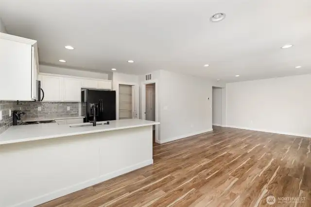 The living area seamlessly flows into the dining room, creating an open and connected space perfect for gatherings and everyday living.