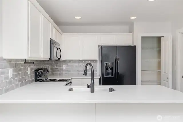 The thoughtfully designed peninsula provides space for a couple of bar stools, perfect for casual dining or entertaining.