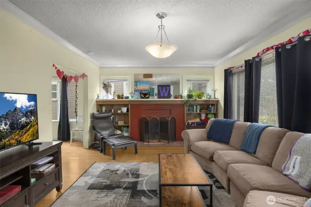 open living room, large windows and wood burning fireplace