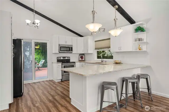Open kitchen with breakfast bar and slider to back deck