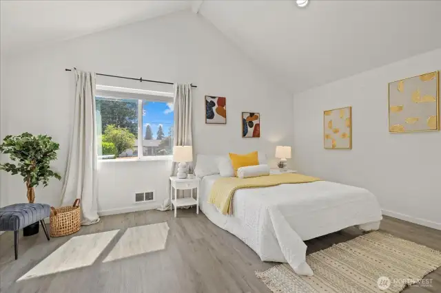 Primary bedroom with vaulted ceilings