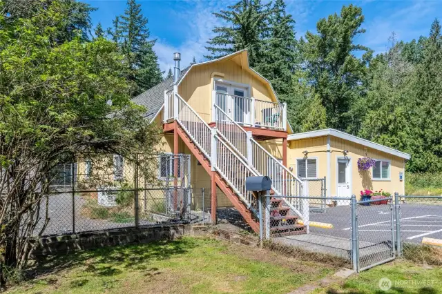 Multiple outbuildings including ADU, dog kennels, 9 fenced dog yards, grooming room, bathrooms, garages, shops, office space.