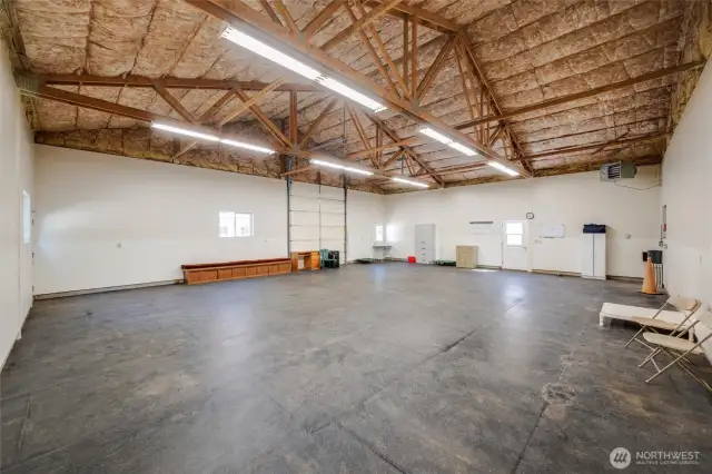 2nd large building behind the admin building. This one is currently the dog training/daycare/excercise room, Extra large garage with tall roll up door. Continue using with dogs or maybe this is where you park all your classic cars?
