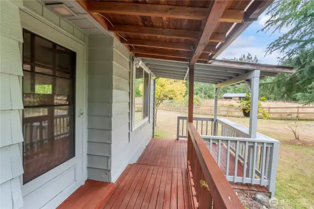 Front door and front porch that leads to both ends of the home.
