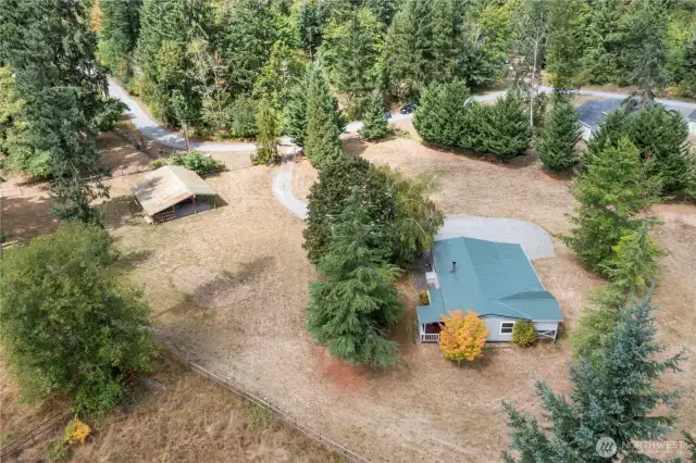 Metal roof covers home and decks, level land means room for your desires! Gardens maybe?