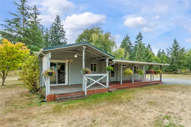 The back of the home boasts huge wood porch fully covered to enjoy year-round!