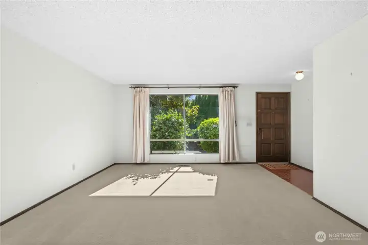 Front entry to living room, coat closet across from door.