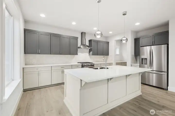 Spacious kitchen has pull outs in lower cabinets.