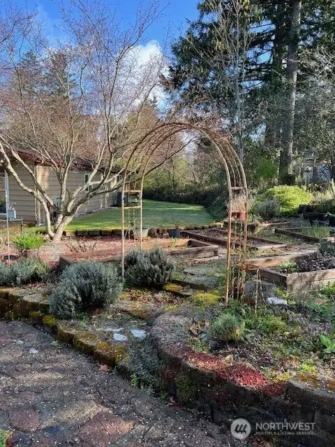 Photo from owner of all the beds to grow your dream garden. Firepit just behind this shot.
