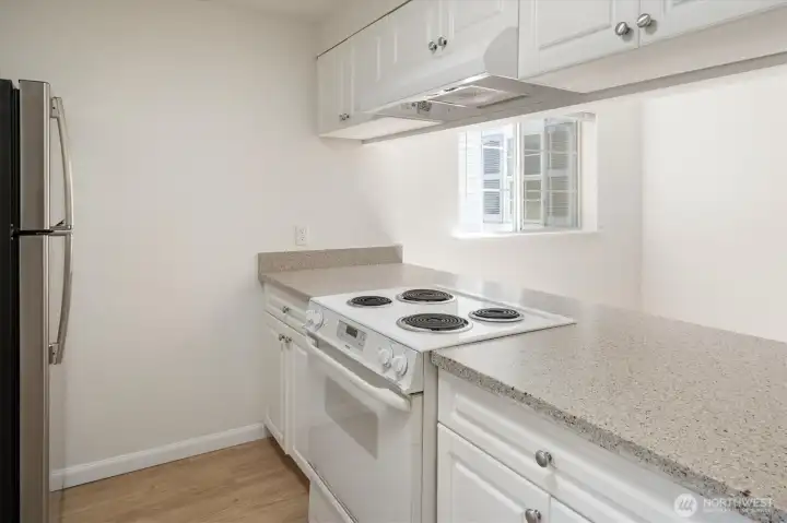 The kitchen is large, well-equipped, and sunny, an excellent space for meal prep.