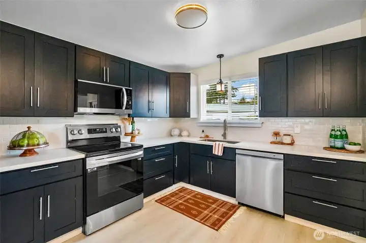 Rich Cabinetry and A Bright Window Over The Kitchen Sink That Fills The Kitchen With Natural Light.