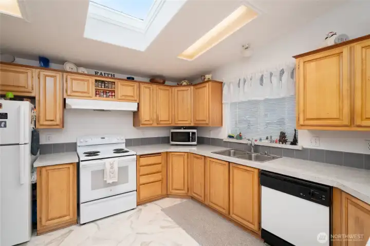 Large skylight adds light! Lots of counters for prep work and oak cabinets for storage!