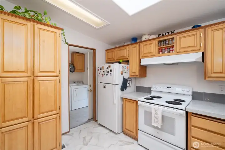 The laundry is right off kitchen with entry from the carport area.  Notice the large pantry cabinet for more storage!