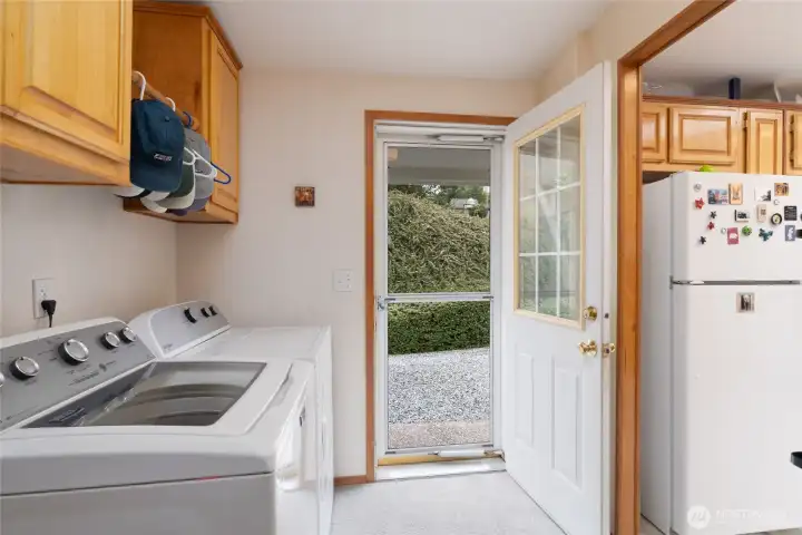 Laundry room with area for air drying. Screen door leads to the carport parking area.
