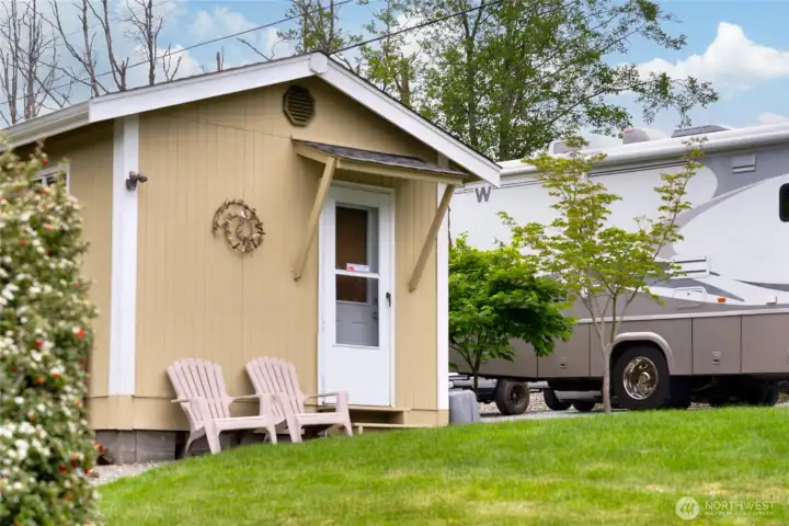 Super cute storage cottage with screen door!