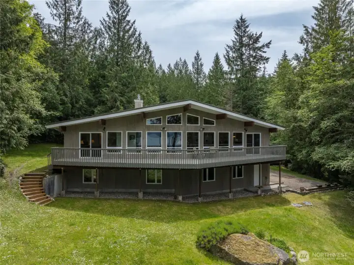 This north end custom home welcomes you to warm and gracious spaces with marine and island views.  It has 3 bedrooms, 2.5 bath and is on 3.8 acres.