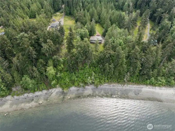 Stairs to the beach from this custom home allows beach walks and small boat activities.
