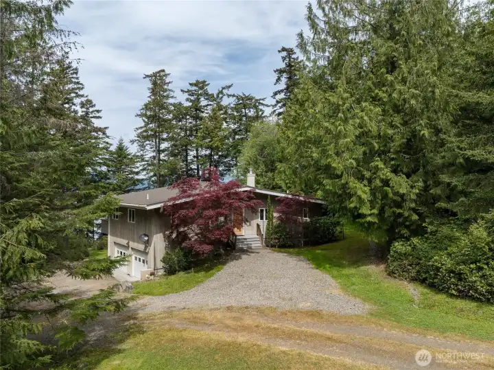 Driveway approach to this well built and maintained home with 2 car garage beneath.