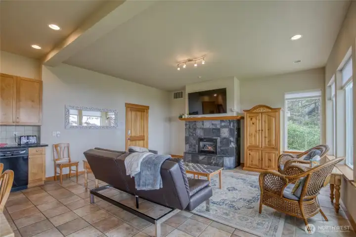 Enter the main level of the home and you're greeted with warm woods, easy care tile floors and a cozy fireplace.