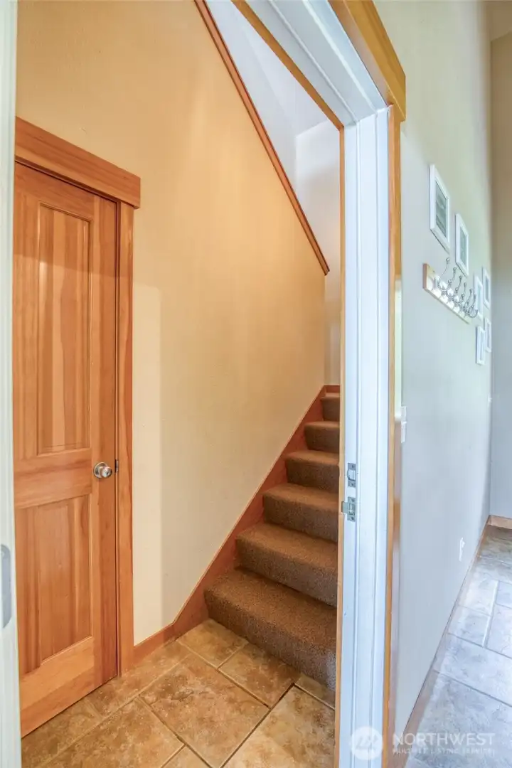 Off the main entry is the door to the upper level stairs.