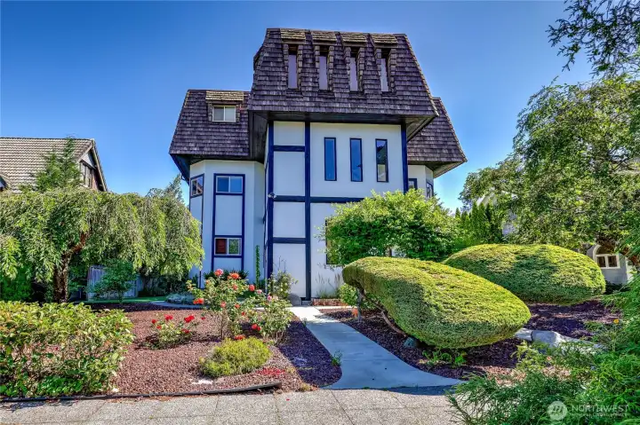Front entry surrounded by meticulously kept gardens.