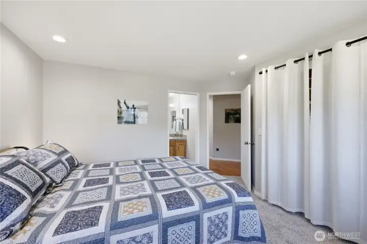 The primary bedroom features an ensuite bathroom, new carpeting, and a spacious closet.