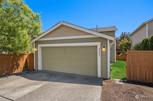 Detached 2 car garage with a side gate to the backyard.