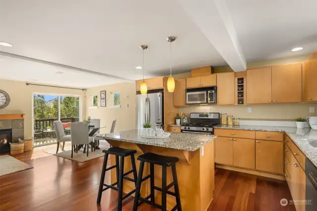 Kitchen with eating bar, dining room and deck