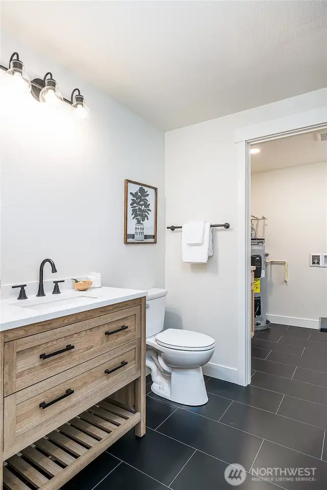 A conveniently located bathroom off the kitchen and dining area, with an adjoining utility room for added functionality